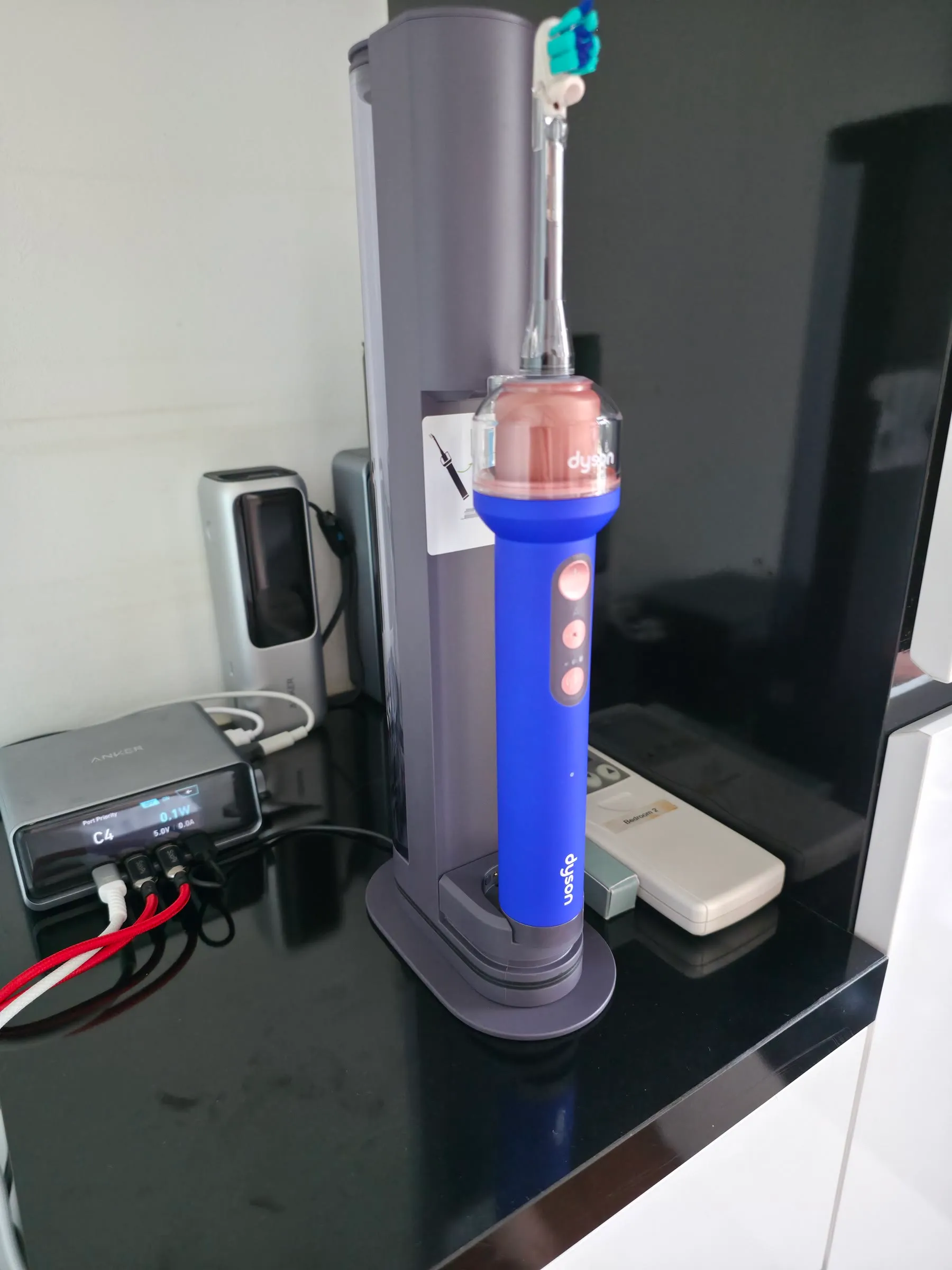 The Dyson CameraJet illuminated in its transparent dock beside power-testing equipment