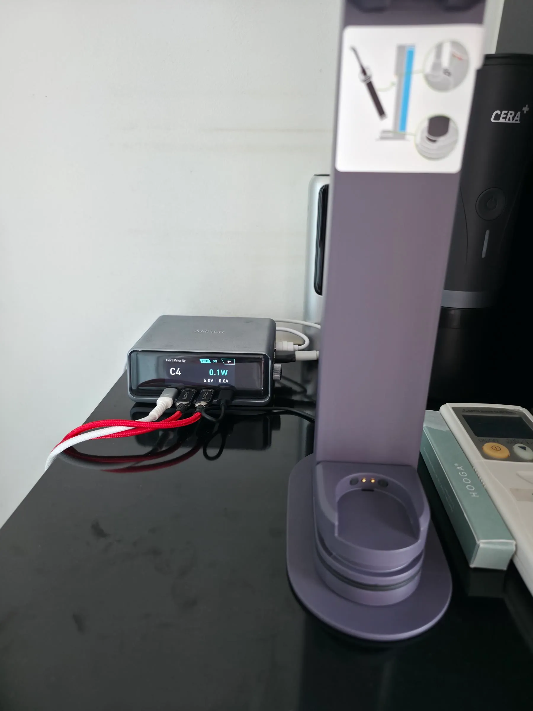 CameraJet dock beside a USB power meter during charging tests